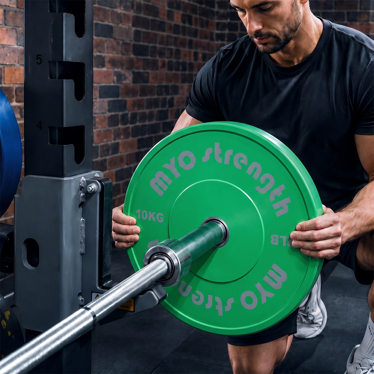 MYO Strength 10kg Olympic coloured bumper plate being loaded onto a barbell
