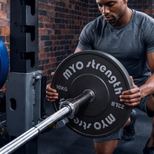 MYO Strength 10kg Olympic rubber bumper plate being loaded onto a barbell