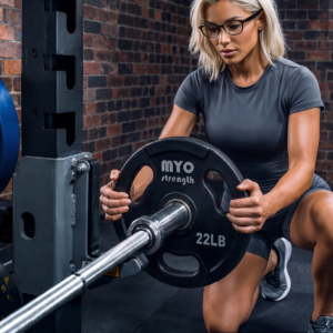 MYO Strength 10kg Olympic urethane plate being loaded onto a barbell